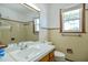 Full bathroom with tan tiling, white vanity, and a mirrored wall at 11234 Nc Hwy 50, Benson, NC 27504