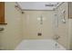 Bathtub and shower with tan tiled walls and safety bars at 11234 Nc Hwy 50, Benson, NC 27504