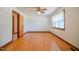 Bedroom with hardwood floors, ceiling fan, and a window for natural light at 11234 Nc Hwy 50, Benson, NC 27504