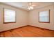 Bright bedroom with hardwood floors, ceiling fan, and two windows at 11234 Nc Hwy 50, Benson, NC 27504
