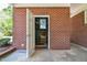 The red brick entrance leads to a storage area with a white door and a concrete floor at 11234 N Nc Hwy 50, Benson, NC 27504