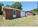 Brick home featuring a large sliding garage door and nice yard at 11234 Nc Hwy 50, Benson, NC 27504