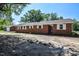 Red brick home with white shutters and a manicured lawn at 11234 Nc Hwy 50, Benson, NC 27504