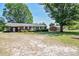 Charming brick home with well-maintained landscaping, complemented by mature trees and a spacious front yard at 11234 N Nc Hwy 50, Benson, NC 27504
