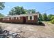Red brick home with white trim and mature trees in a large yard at 11234 N Nc Hwy 50, Benson, NC 27504