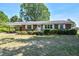 Charming single-story brick home featuring manicured hedges, white shutters and covered parking at 11234 Nc Hwy 50, Benson, NC 27504