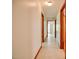 Hallway with access to multiple rooms, neutral paint, and tile flooring at 11234 N Nc Hwy 50, Benson, NC 27504