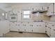 Classic kitchen with white cabinetry, tiled floors, and built-in appliances at 11234 Nc Hwy 50, Benson, NC 27504
