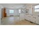 Bright, combined kitchen and dining area features white cabinets and neutral flooring at 11234 Nc Hwy 50, Benson, NC 27504