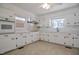 Bright kitchen featuring classic white cabinets, tiled countertops, and stainless-steel appliances at 11234 Nc Hwy 50, Benson, NC 27504