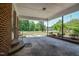 This spacious covered patio features brick accents, concrete flooring, and green landscaping views at 11234 N Nc Hwy 50, Benson, NC 27504