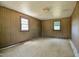 Vacant room with wood paneling and natural light streaming through the windows, ready for customization at 11234 Nc Hwy 50, Benson, NC 27504