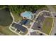Aerial view of community pool, clubhouse, parking and surrounding green spaces and a pond at 116 Alumroot Rd, Holly Springs, NC 27540