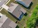 Aerial shot of the backyard with a patio, landscaping, well maintained lawn, and fenced in yard at 116 Alumroot Rd, Holly Springs, NC 27540
