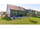 Home exterior showcasing a spacious backyard, grill, and lounge seating at 116 Alumroot Rd, Holly Springs, NC 27540