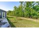 Manicured backyard with green lawn and fence at 116 Alumroot Rd, Holly Springs, NC 27540