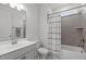 Clean bathroom with a shower-tub combo, contemporary vanity, and neutral color palette at 116 Alumroot Rd, Holly Springs, NC 27540