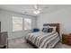 Comfortable bedroom featuring natural light and a ceiling fan at 116 Alumroot Rd, Holly Springs, NC 27540