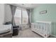 Light-filled Bedroom with a crib, soft furnishings, and a tranquil atmosphere at 116 Alumroot Rd, Holly Springs, NC 27540