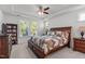 Comfortable bedroom features a large window and ceiling fan at 116 Alumroot Rd, Holly Springs, NC 27540