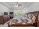 Large bedroom features a ceiling fan and an abundance of natural light at 116 Alumroot Rd, Holly Springs, NC 27540