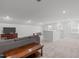 Large bonus room with plush carpeting and recessed lighting at 116 Alumroot Rd, Holly Springs, NC 27540