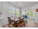 Sunlit dining area with a wooden table and bench seating, perfect for Gathering gatherings at 116 Alumroot Rd, Holly Springs, NC 27540