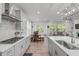 Spacious kitchen with white cabinetry, a center island, and open layout connecting to the dining area at 116 Alumroot Rd, Holly Springs, NC 27540