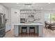 Bright kitchen featuring stainless steel appliances, a center island with seating, and stylish pendant lighting at 116 Alumroot Rd, Holly Springs, NC 27540