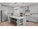 Modern kitchen with a center island, stainless steel appliances, and a light, airy feel at 116 Alumroot Rd, Holly Springs, NC 27540