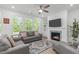 Bright living room features a fireplace and large windows at 116 Alumroot Rd, Holly Springs, NC 27540