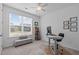 Cozy home office with a large window providing natural light, complemented by neutral decor at 116 Alumroot Rd, Holly Springs, NC 27540