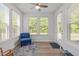 Bright sun room featuring many windows, a ceiling fan, and LVP flooring at 116 Alumroot Rd, Holly Springs, NC 27540