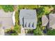 Birds-eye view of home with a gray roof, driveway, landscaping and back deck at 116 Weaver Mine Trl, Chapel Hill, NC 27517