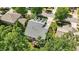 Aerial view of a home with a well-maintained roof, landscaping, and inviting outdoor deck surrounded by trees at 116 Weaver Mine Trl, Chapel Hill, NC 27517