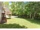 Spacious backyard with a deck and a white picket fence and mature trees at 116 Weaver Mine Trl, Chapel Hill, NC 27517