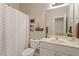 Bathroom features a decorative shower curtain, toilet and a large mirror above the sink at 116 Weaver Mine Trl, Chapel Hill, NC 27517