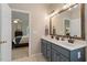 Bathroom features a double vanity with gray cabinets and a view to the bedroom at 116 Weaver Mine Trl, Chapel Hill, NC 27517