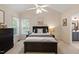 Bright bedroom featuring neutral walls, a ceiling fan, and a dark wood furniture set at 116 Weaver Mine Trl, Chapel Hill, NC 27517