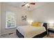 Bedroom showcasing neutral walls, a ceiling fan, and large window for natural light at 116 Weaver Mine Trl, Chapel Hill, NC 27517