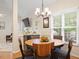 Cozy dining area with a wooden table, views of the backyard, and backyard access at 116 Weaver Mine Trl, Chapel Hill, NC 27517