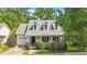 Inviting home showcasing a covered porch, dormer windows, an attached garage, and manicured landscaping at 116 Weaver Mine Trl, Chapel Hill, NC 27517