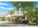 Inviting front exterior with covered porch, dormer windows, attached garage, and mature trees at 116 Weaver Mine Trl, Chapel Hill, NC 27517