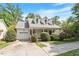 Charming home featuring dormer windows, attached garage, covered porch, and lush landscaping at 116 Weaver Mine Trl, Chapel Hill, NC 27517