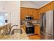 Kitchen featuring a stainless refrigerator, oven, and granite countertops at 116 Weaver Mine Trl, Chapel Hill, NC 27517