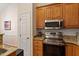 Kitchen featuring stainless appliances, granite counters and adjacent doorway at 116 Weaver Mine Trl, Chapel Hill, NC 27517
