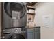 Laundry room featuring a stacked washer and dryer and built-in shelving at 116 Weaver Mine Trl, Chapel Hill, NC 27517