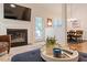 Bright living room with fireplace, a large window, and an adjacent dining area at 116 Weaver Mine Trl, Chapel Hill, NC 27517