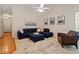 Spacious living room with a comfortable couch, accent chair, and stylish decor at 116 Weaver Mine Trl, Chapel Hill, NC 27517