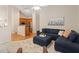 Cozy living room features a comfortable blue sectional sofa and a view into the kitchen at 116 Weaver Mine Trl, Chapel Hill, NC 27517